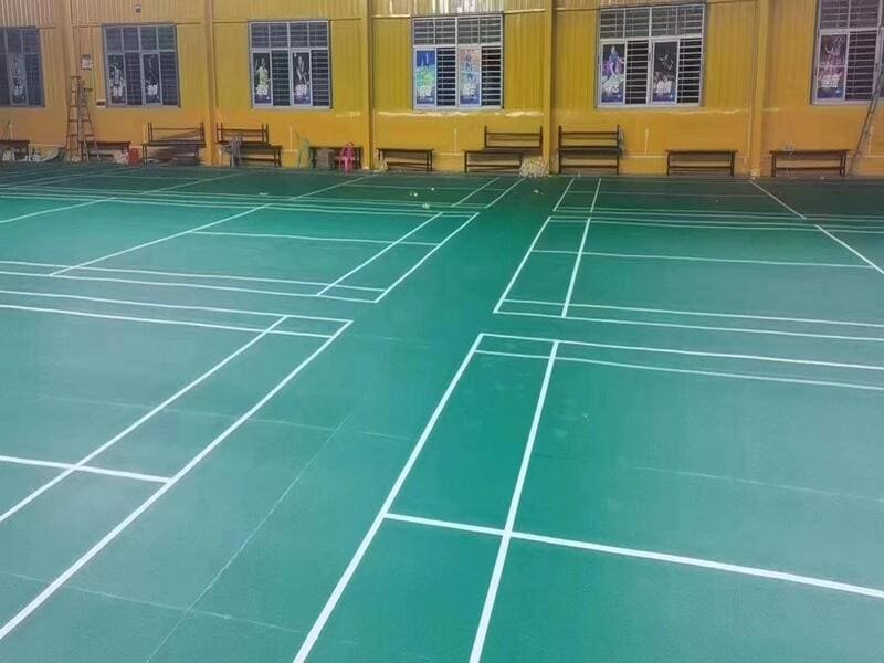 Manufacturer reviewing cutting layout plan for PVC sports flooring